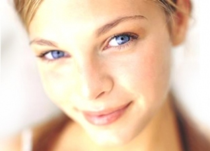 Usmívající se tvář ženy s modrýma očima
